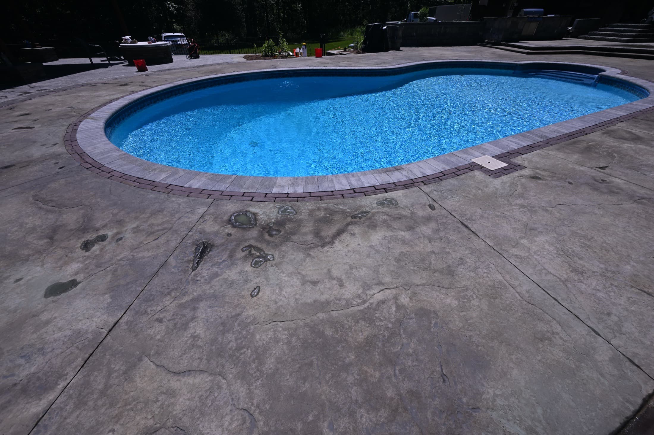 Weathered, dull pool deck concrete before acid staining in Crawford, NY