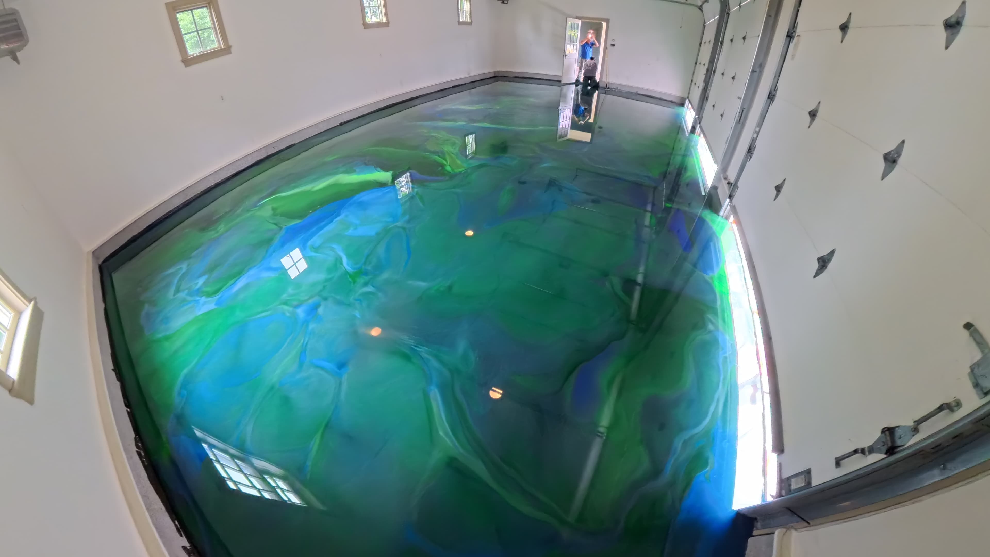 High-gloss blue and green metallic epoxy floor across a 2,000-square-foot garage in Amenia, NY
