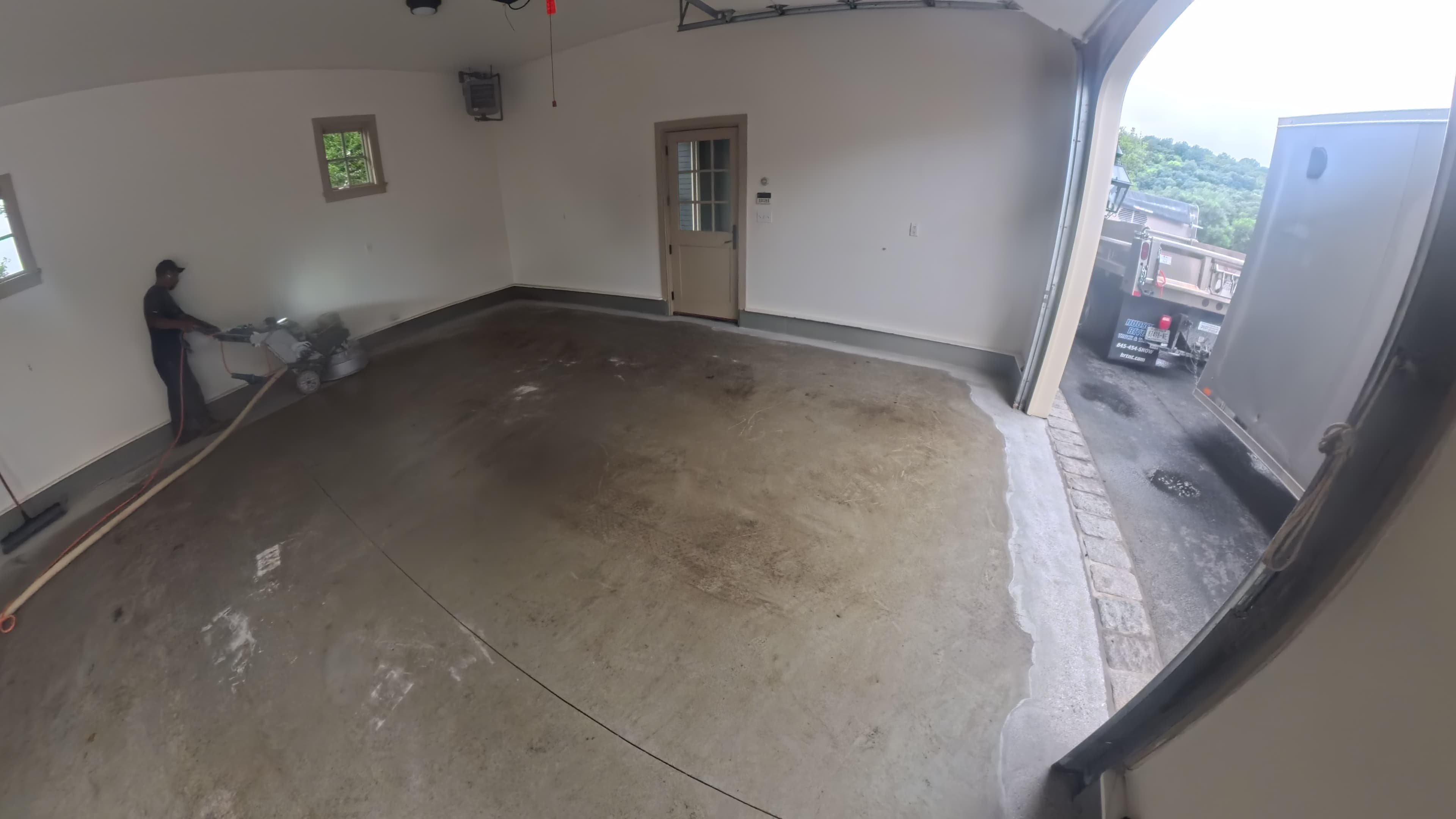 Stained bare concrete garage floor as grinding begins in Amenia, NY