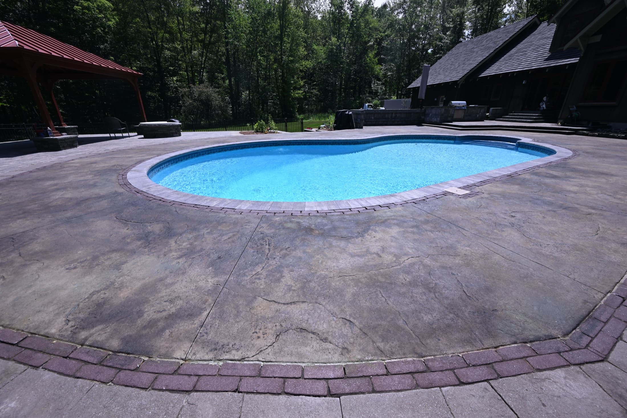 Acid-stained pool deck with a rich, natural stone finish in Crawford, NY