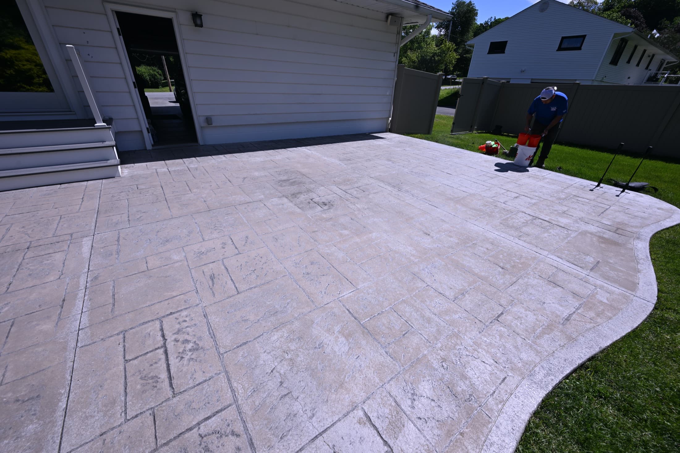 Sun-faded, washed-out stamped concrete patio before antiquing and color in Poughkeepsie, NY