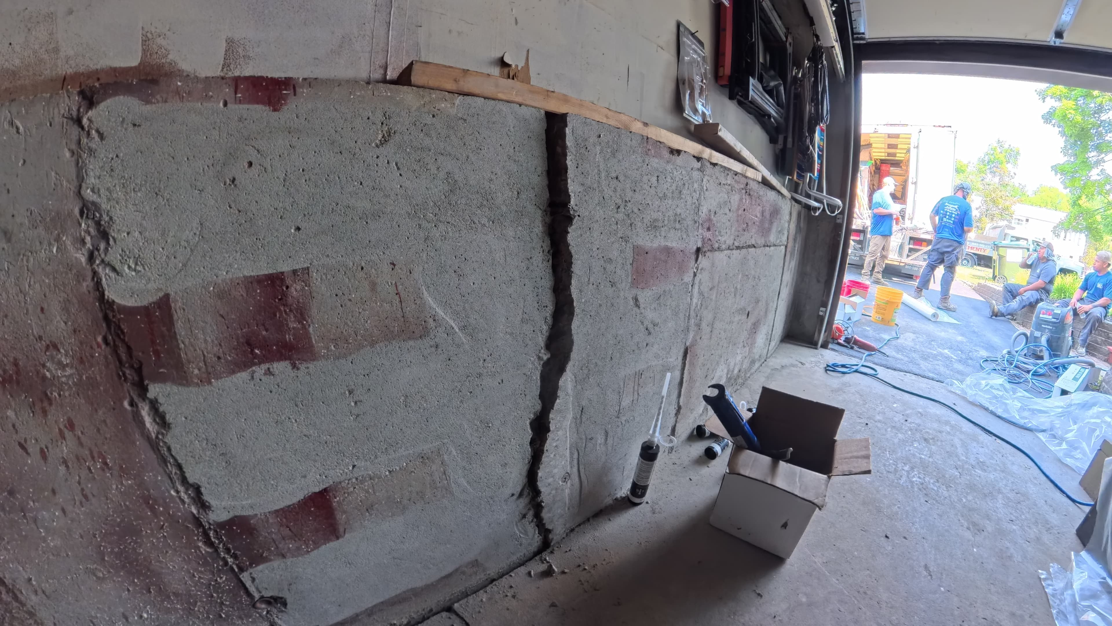 Bowed garage foundation wall with a wide vertical crack before repair in Washingtonville, NY