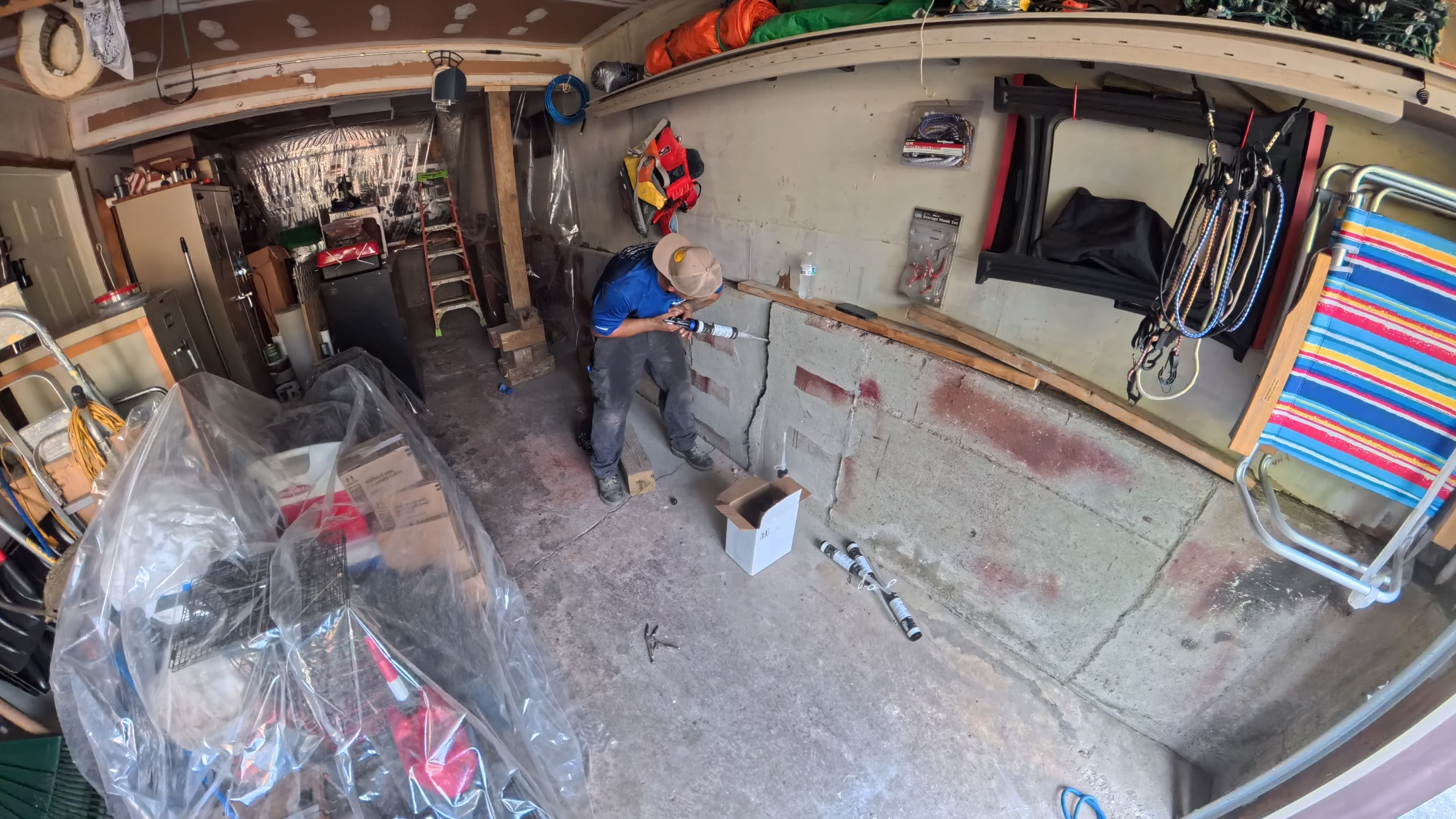Technician sealing garage wall cracks with polyurethane injection in Washingtonville, NY