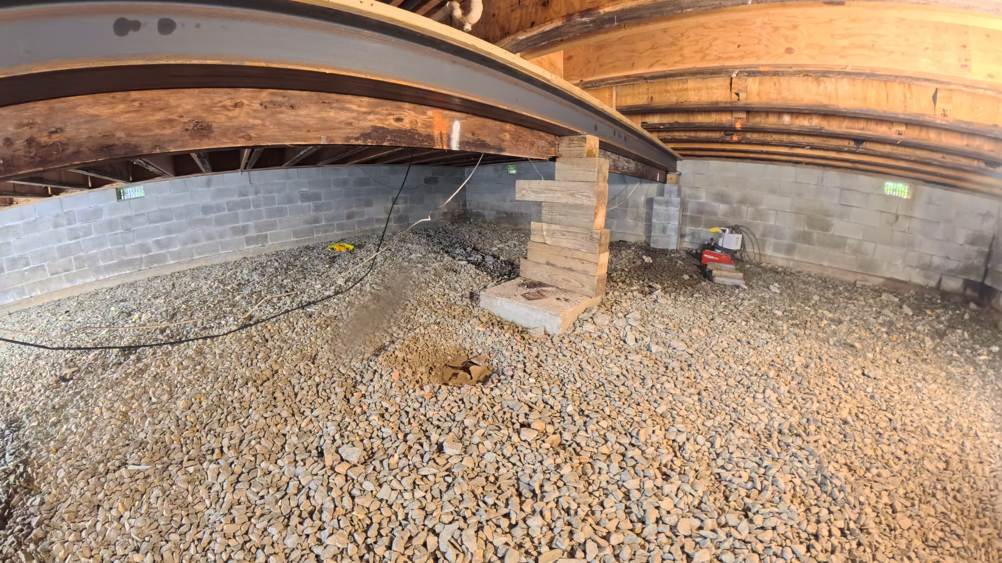 Temporary timber cribbing supporting a steel beam in the infirmary crawl space in Barryville, NY