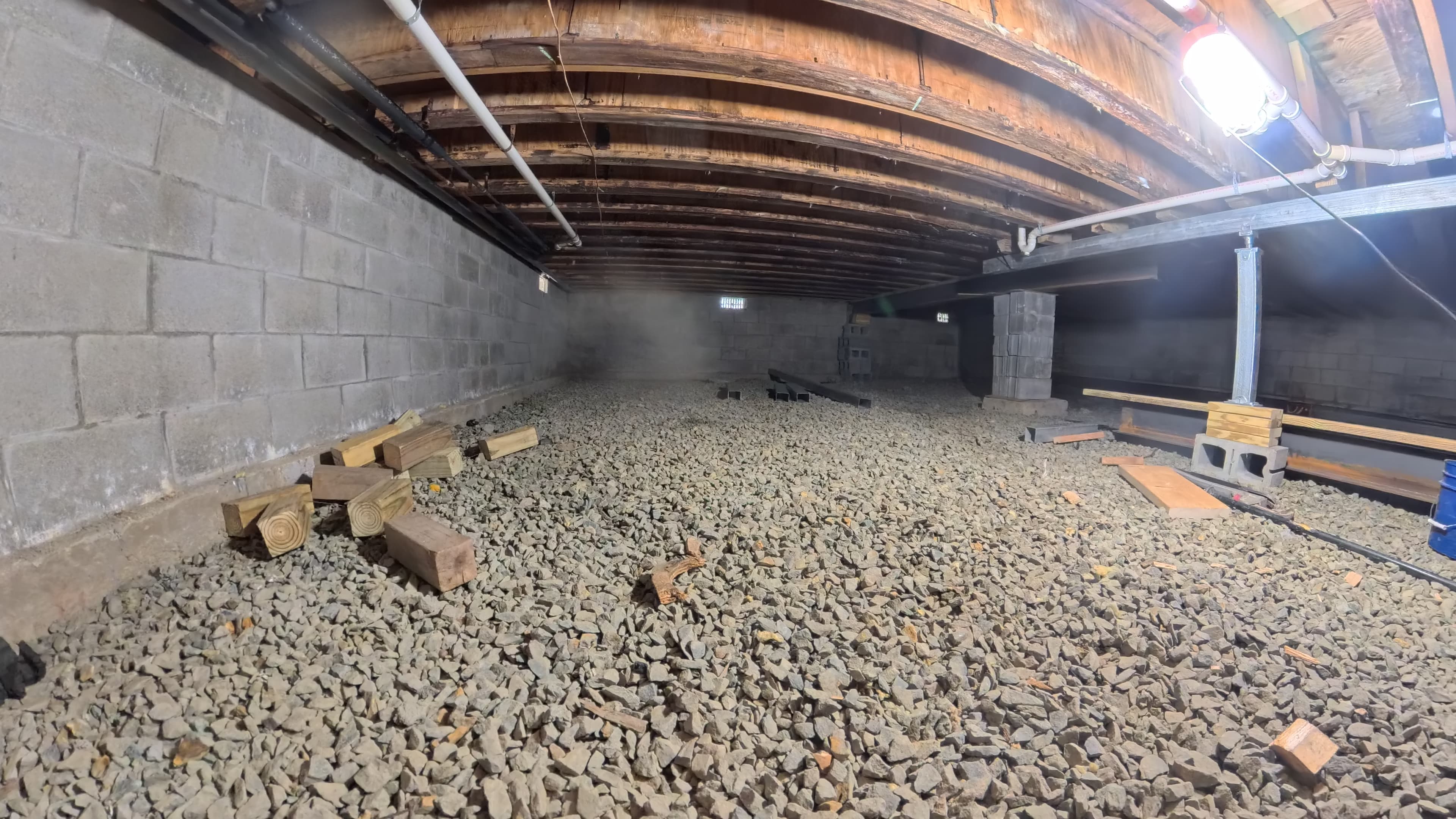 Infirmary crawl space along the block foundation wall during structural repair in Barryville, NY