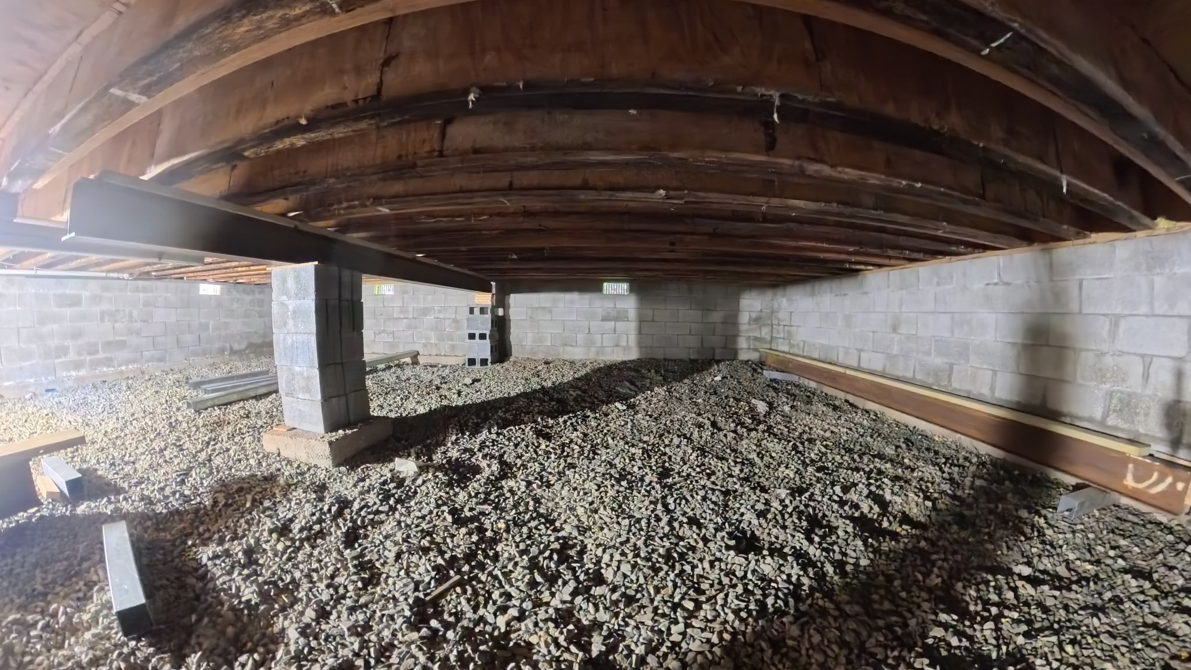 Steel beam staged along the foundation wall in the infirmary crawl space in Barryville, NY
