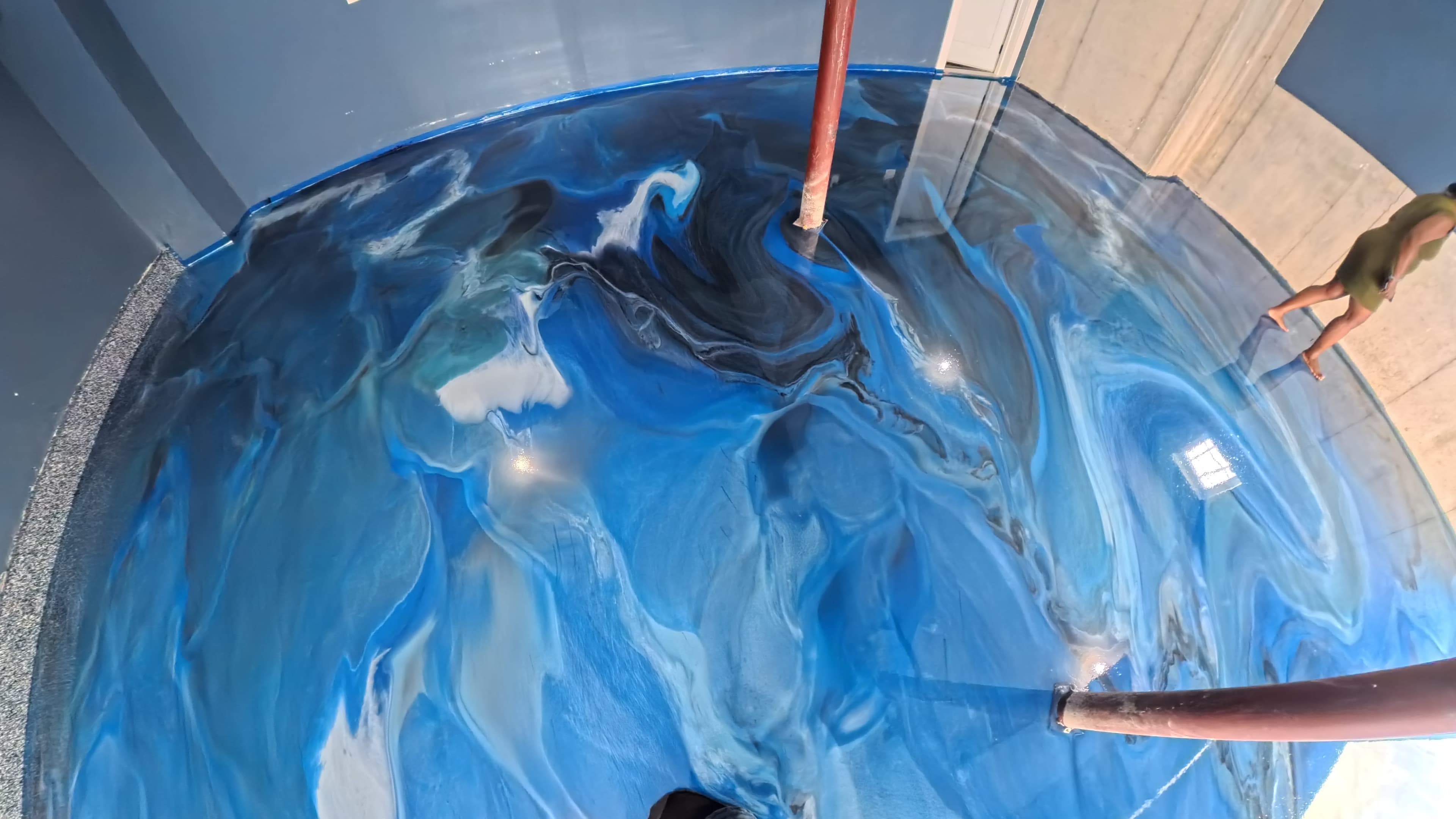 High-gloss blue metallic epoxy floor around the garage support posts in Wallkill, NY