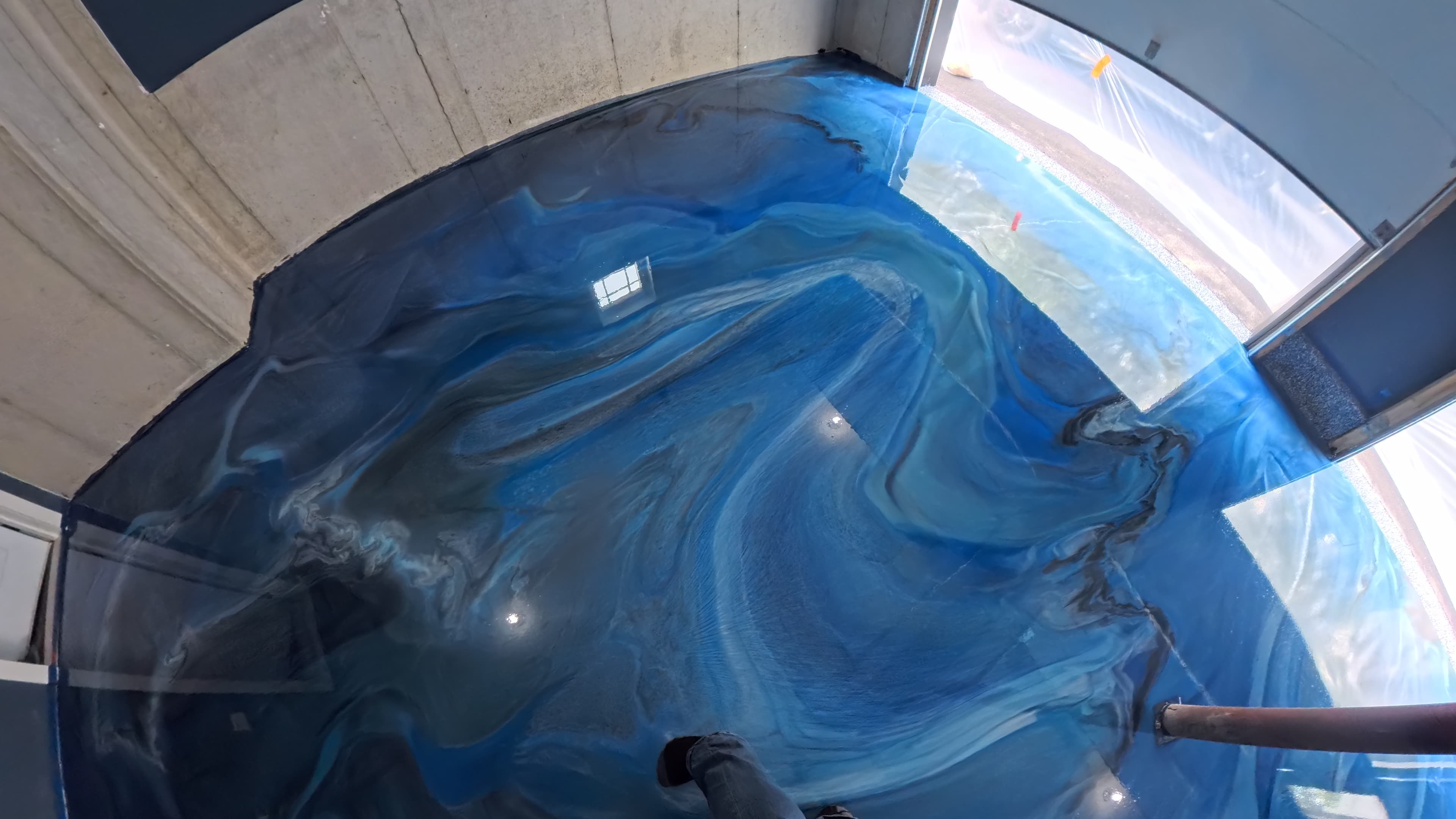 Swirling Bugaloo Blue epoxy pattern across the garage floor in Wallkill, NY