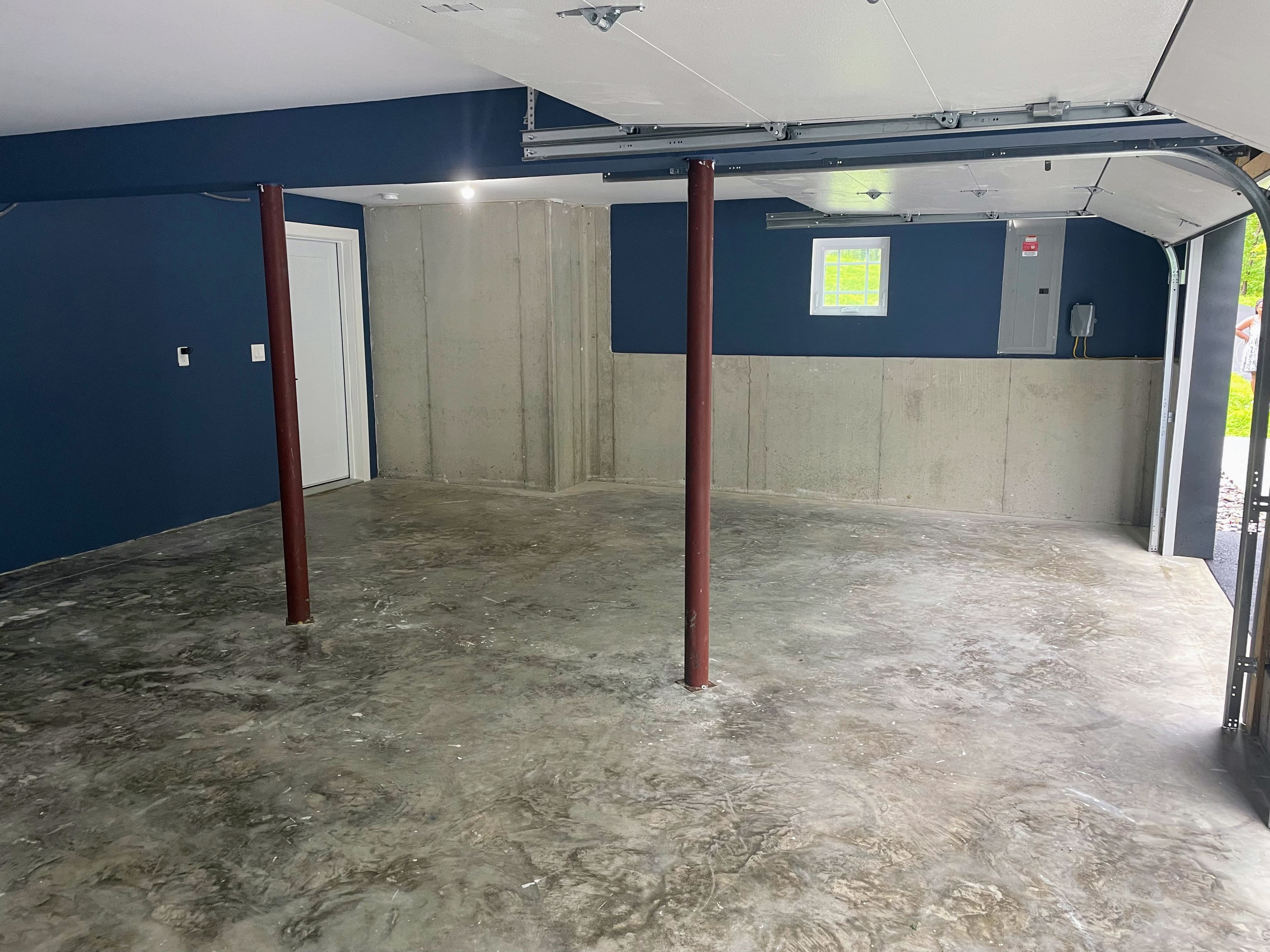 Stained, deteriorating concrete garage floor before epoxy in Wallkill, NY