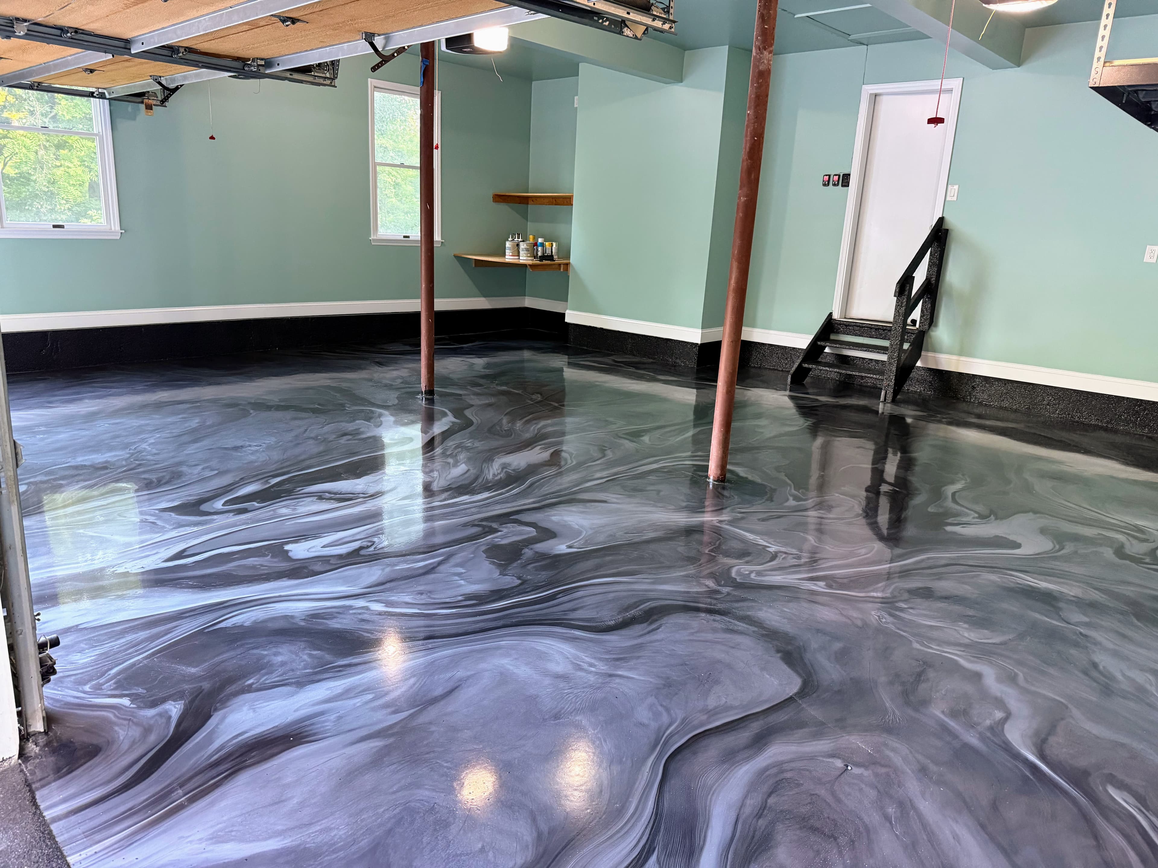 Finished swirl epoxy garage floor with flake epoxy stairs and wall base in Chester, NY