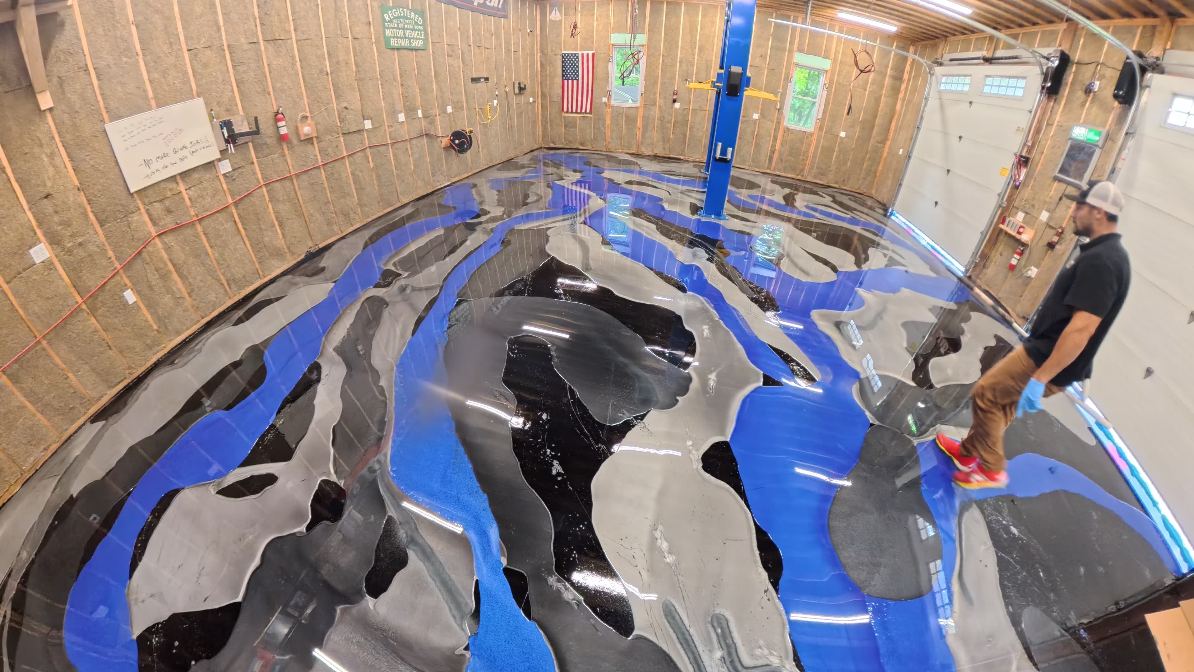 Custom blue, black, and silver pigments being laid down for a waterfall epoxy effect in Kerhonkson, NY