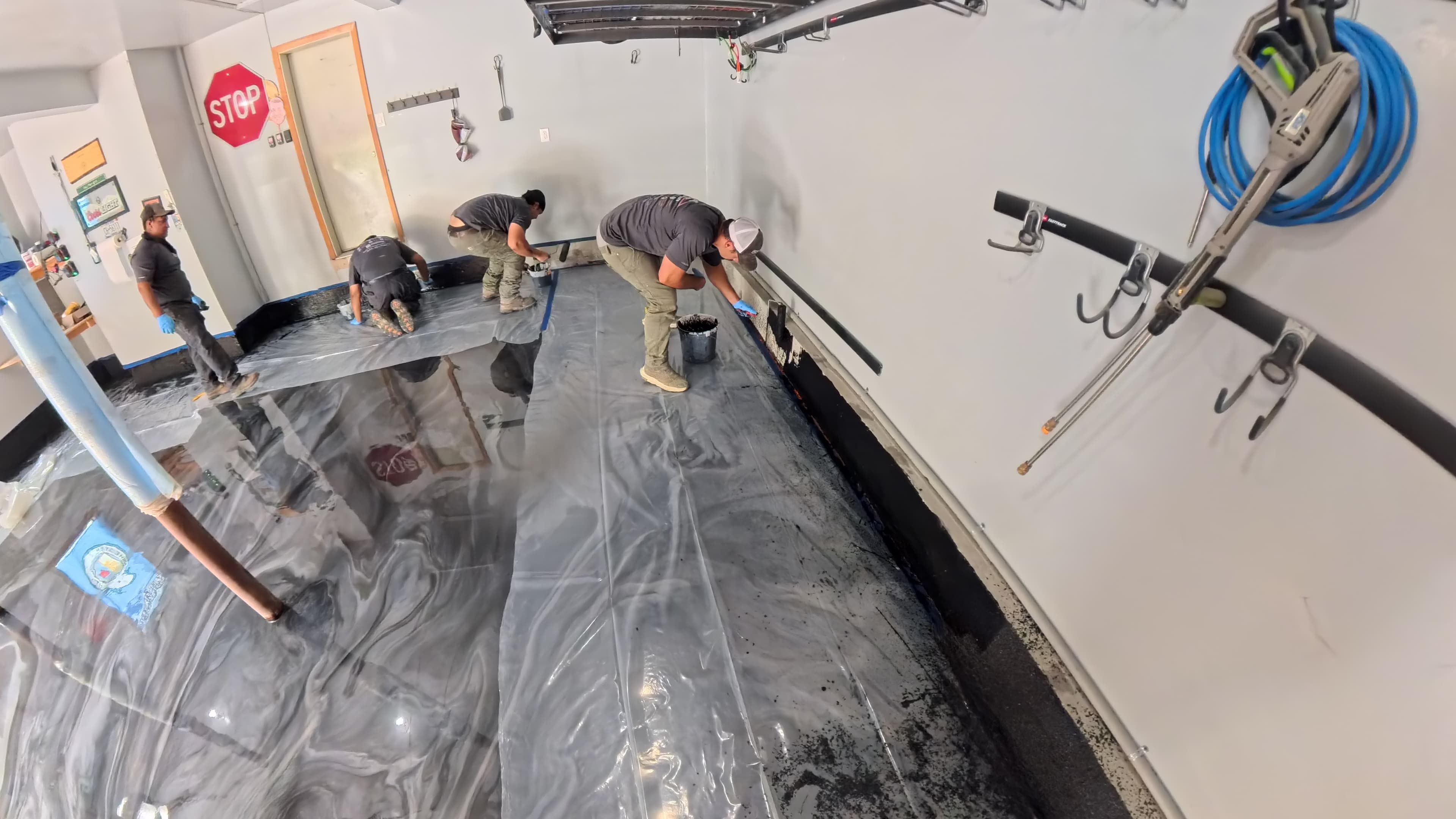Crew applying flake epoxy to the garage walls in Chester, NY