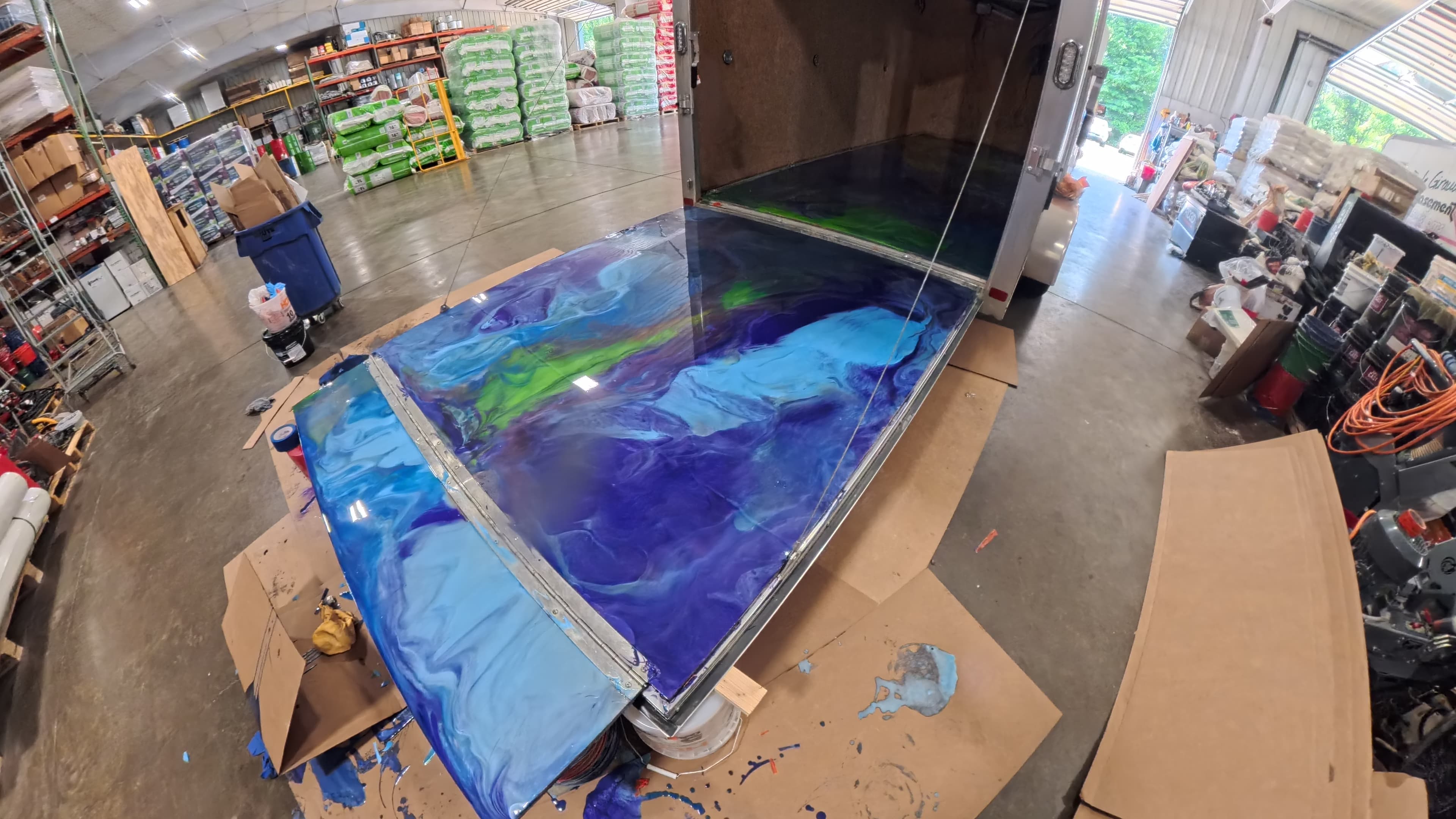 Custom blue, purple, and green swirl epoxy poured across the trailer ramp door in Bullville, NY