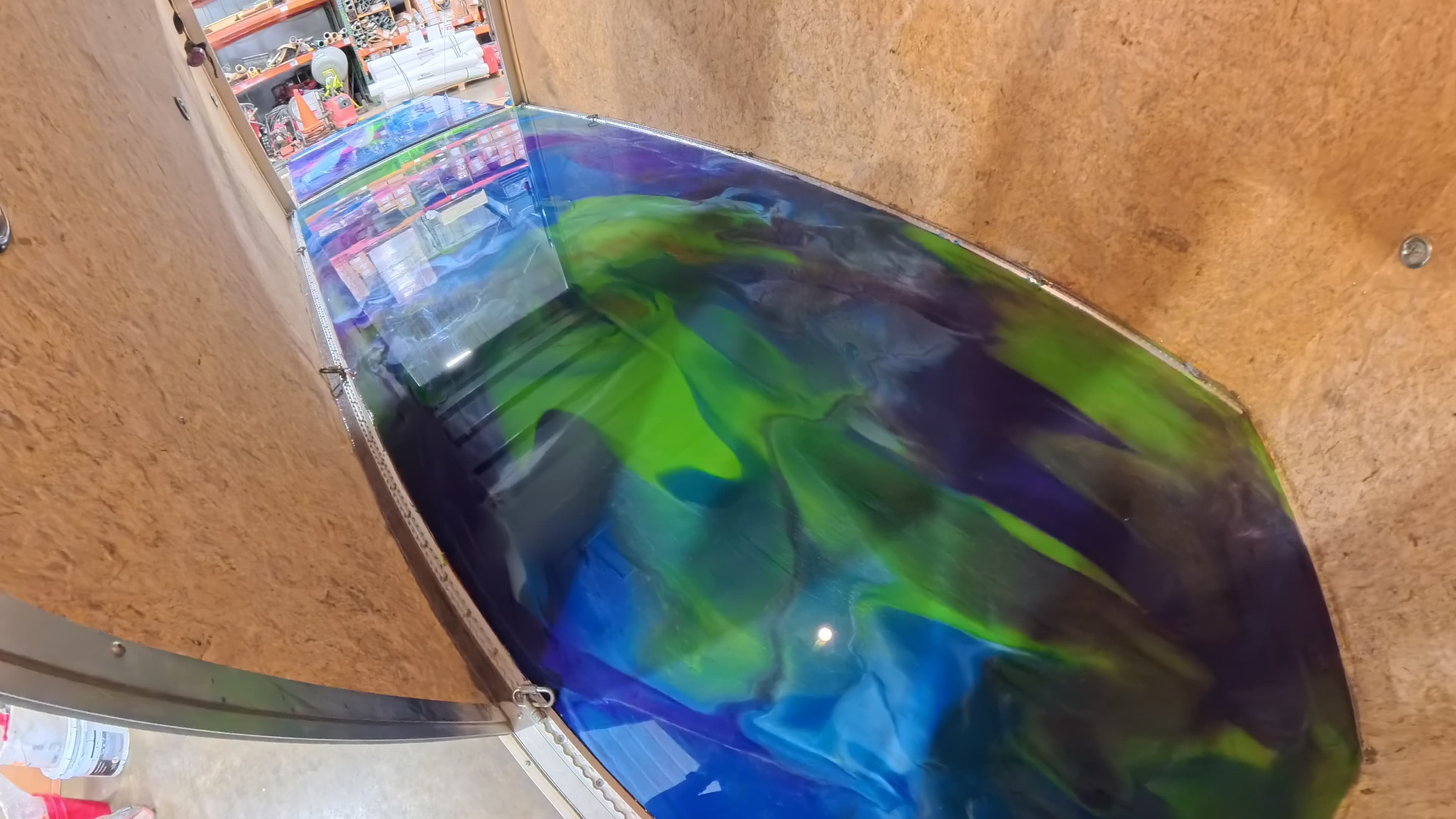 Looking into the trailer at the glossy blue and green epoxy floor in Bullville, NY
