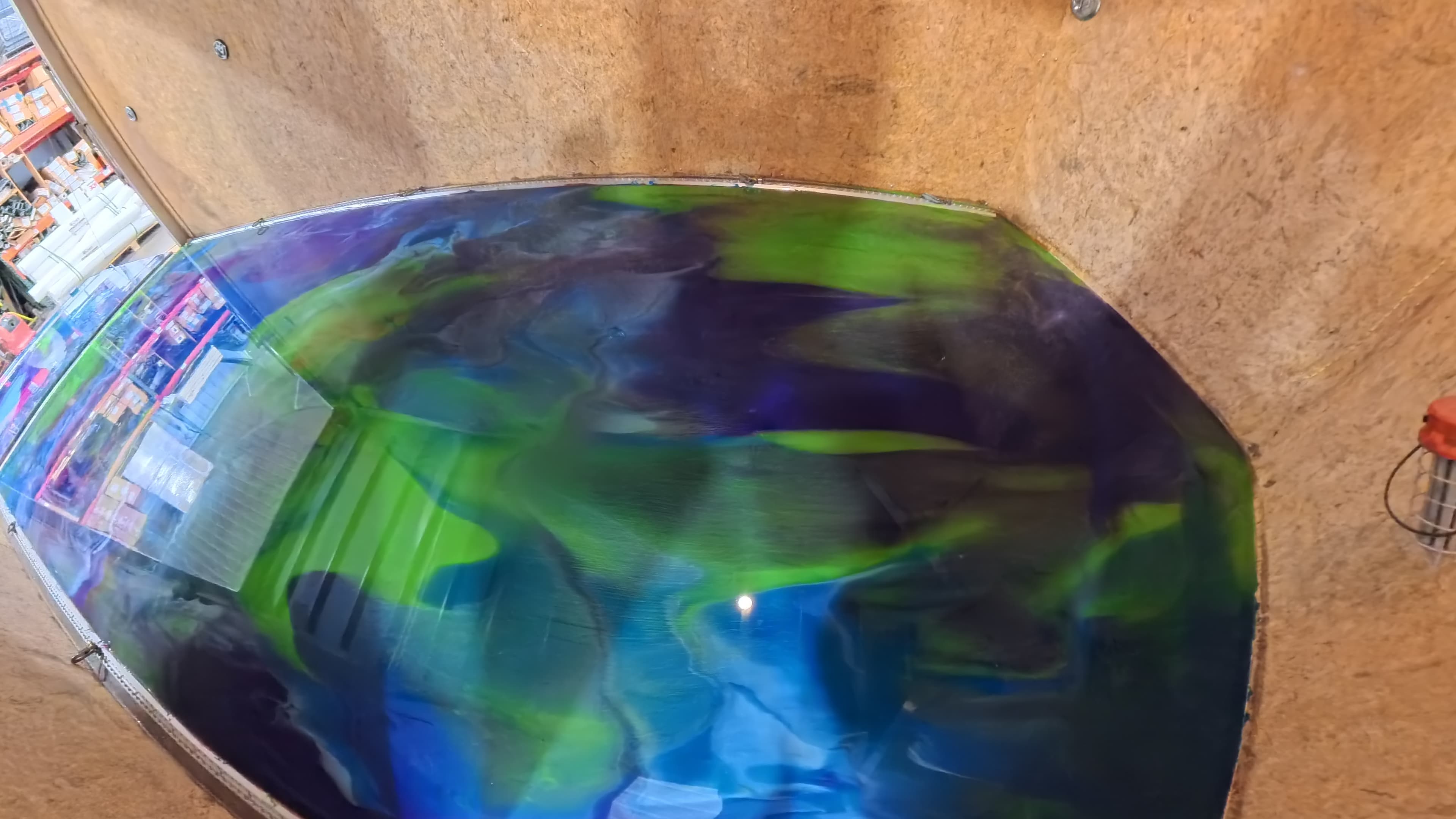 Blue, purple, and green epoxy trailer floor reflecting the shop lights in Bullville, NY